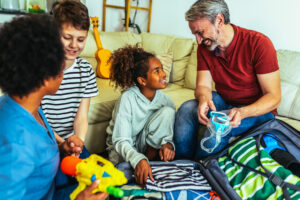 Happy family packs and prepares for traveling on a plane with an autistic child