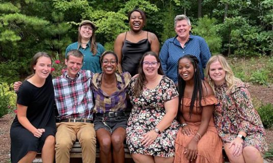 Group shot of Camp Royall staff, all smiling.