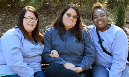 Camp counselors pose together in their ASNC gear.