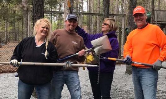 Volunteers helping on a work day around the camp grounds.