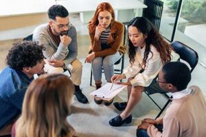 An team of different health care professionals meeting to discuss care planning