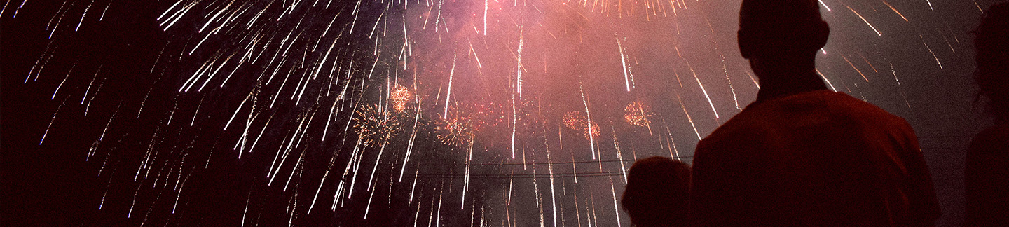 autistic child watching fireworks with their parent