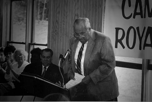 A man takes the podium to speak at Cap Royall.