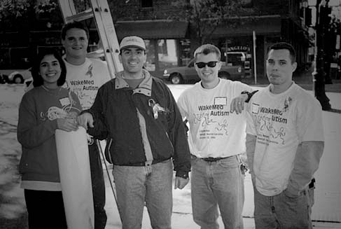 A group of volunteers smile for a picture on a work day.