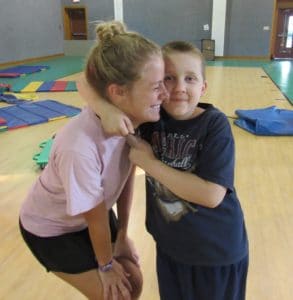 James and a counselor in the gym at Camp Royall, an autism summer camp