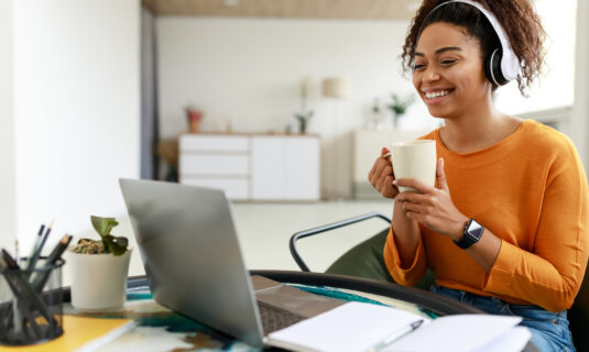 An autistic adult who is enjoying coffee and working from home.