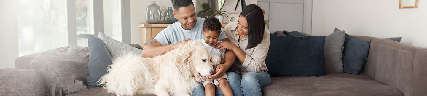 Pets and Autism. A family and their autistic son with their beloved dog on the sofa.