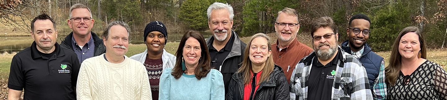 The board of Directors smile for a group photo.