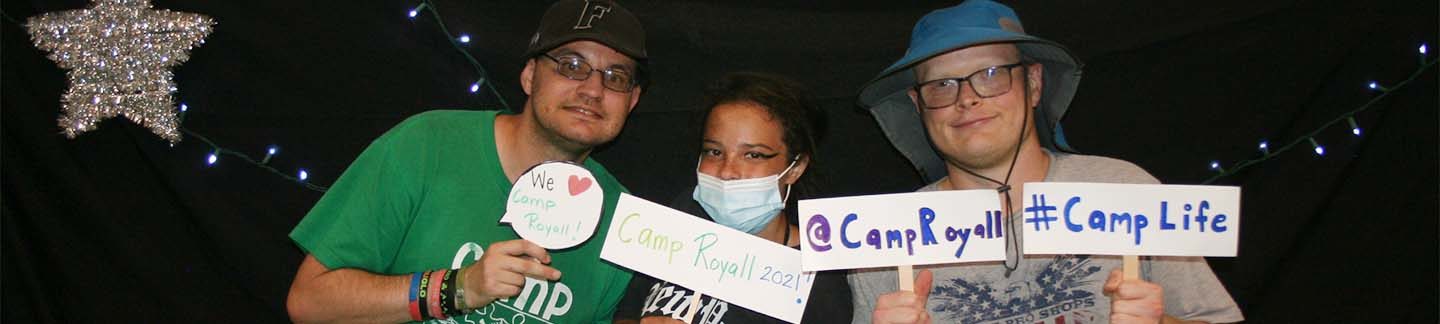 Campers holding signs, praising Camp Royall.