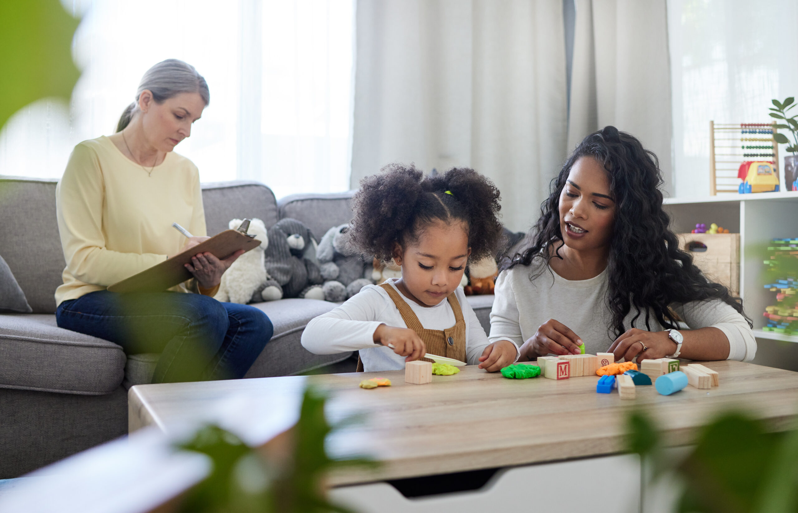 A child is being assessed by a therapist.