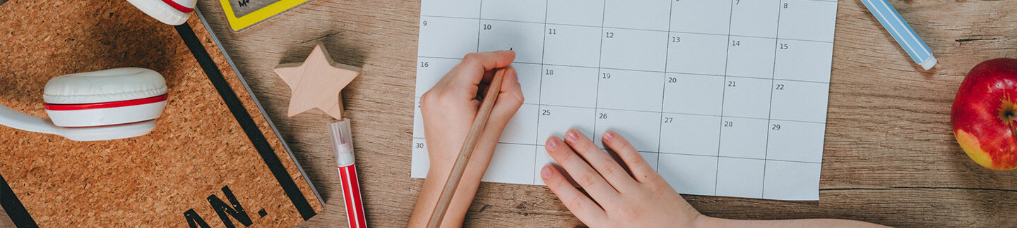 A child writing on a calendar