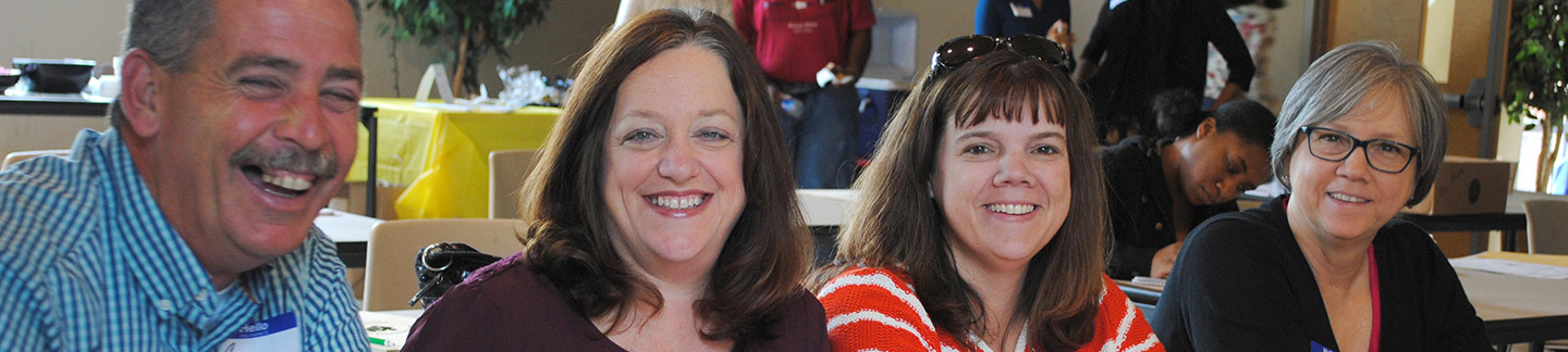 Smiling autism conference registration attendees.