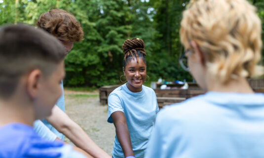 Volunteer group outside at camp