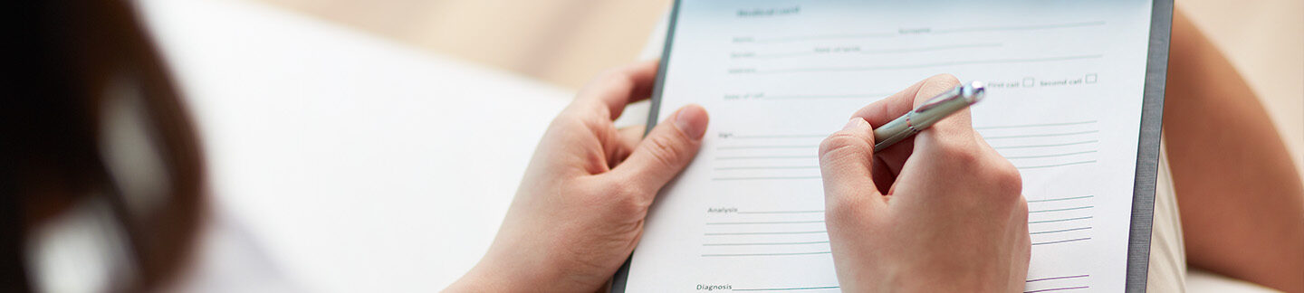 Therapist taking notes for a patient pursuing a diagnosis for autism.