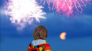 A small child watching fireworks.